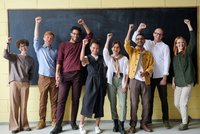 Group of people standing in front of a board