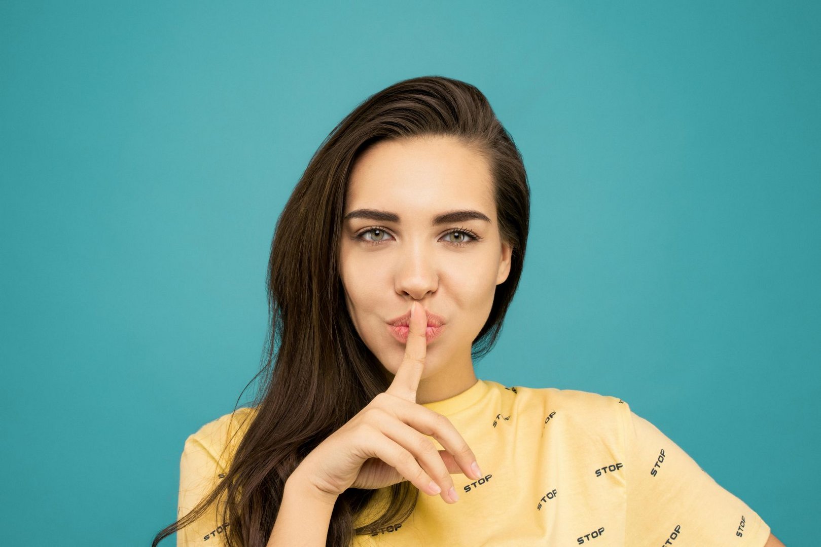 woman with index finger in front of mouth