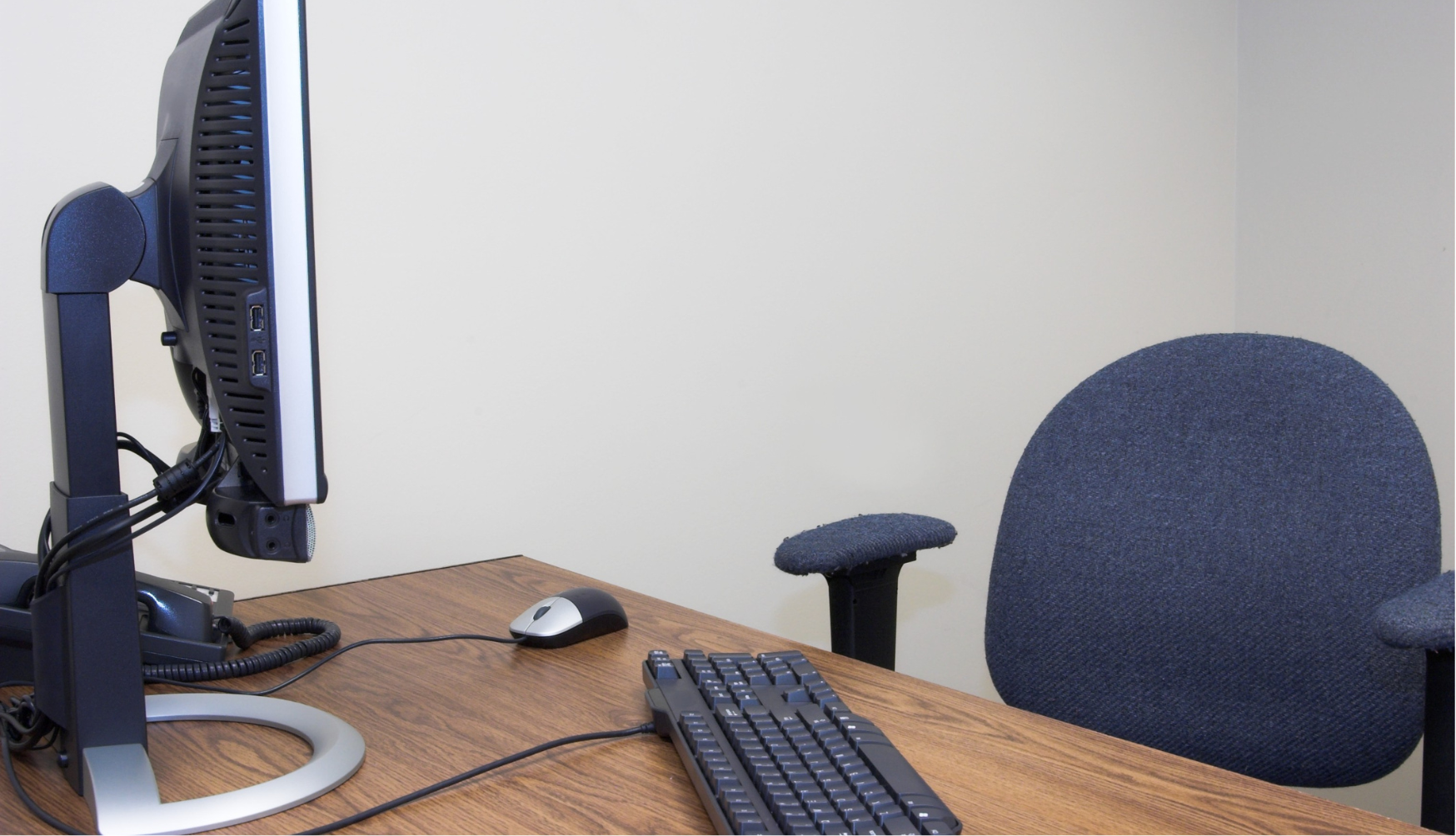 Empty desk with computer and desk chair